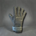 Black goalkeeper glove with a textured pattern and a wrist strap featuring the word SILENCE
